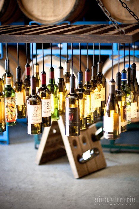 30 Wine Bottle Light Chandelier Hanging from Wood Rack