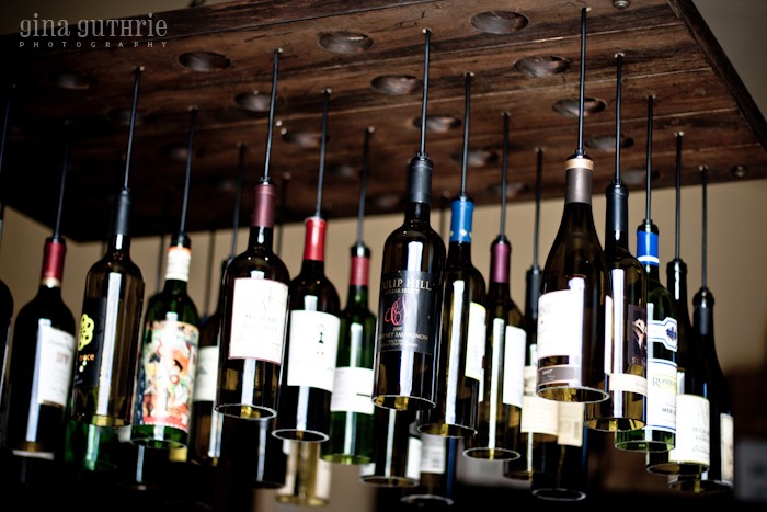 30 Wine Bottle Light Chandelier Hanging from Wood Rack