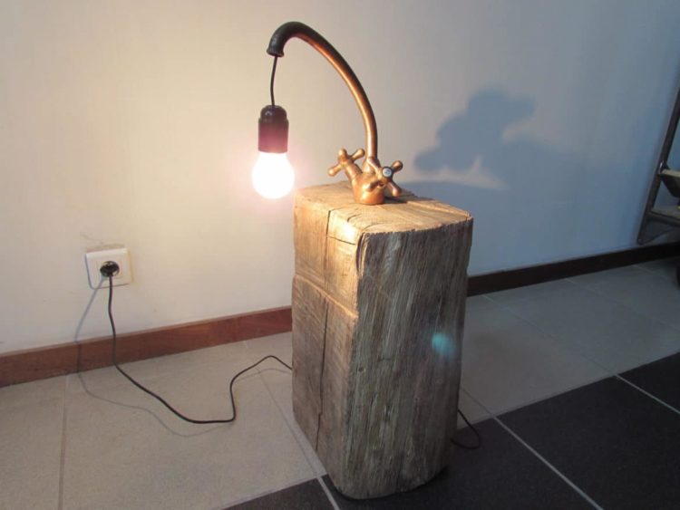 Copper Faucet Lamp on Wood Log