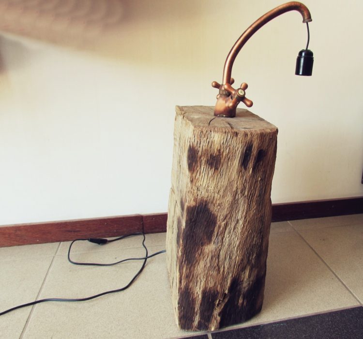 Copper Faucet Lamp on Wood Log